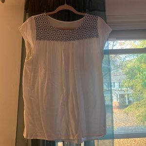 Serra white top with blue flower cutouts.